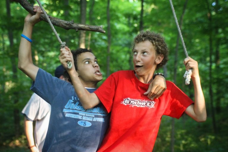 Two boys making silly faces at the ropes course