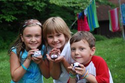 three children with stuffed animals at family camp
