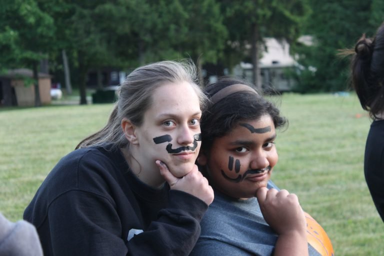 Two teen girls posing with silly eye black