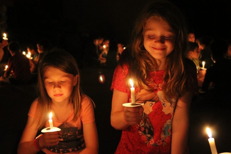 Two girls holding candles at a special event