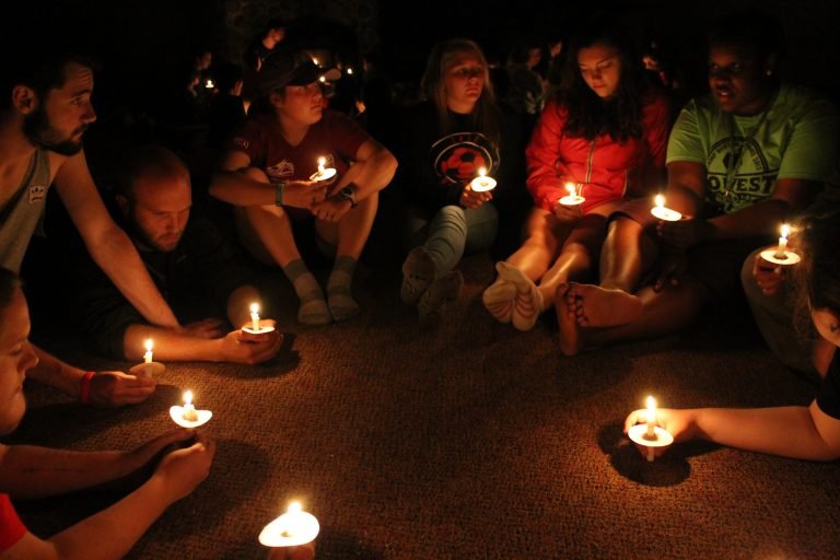 People in a circle holding candles